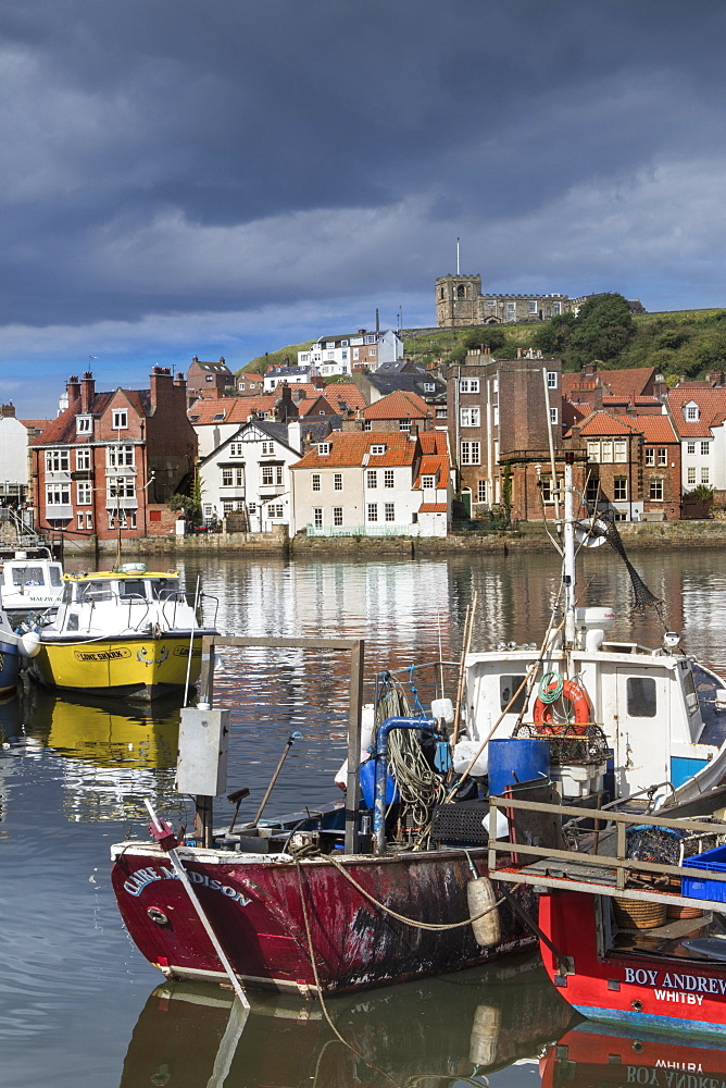 View of fishing boats in the harbour and the town centre, Whitby, Yorkshire, England, United Kingdom, Europe