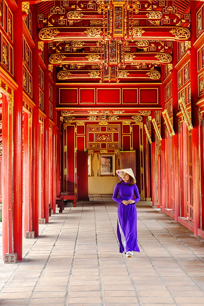 A woman in a traditional Ao Dai dress and Non La conical hat in the Forbidden Purple City of Hue, UNESCO World Heritage Site, Thua Thien Hue, Vietnam, Indochina, Southeast Asia, Asia