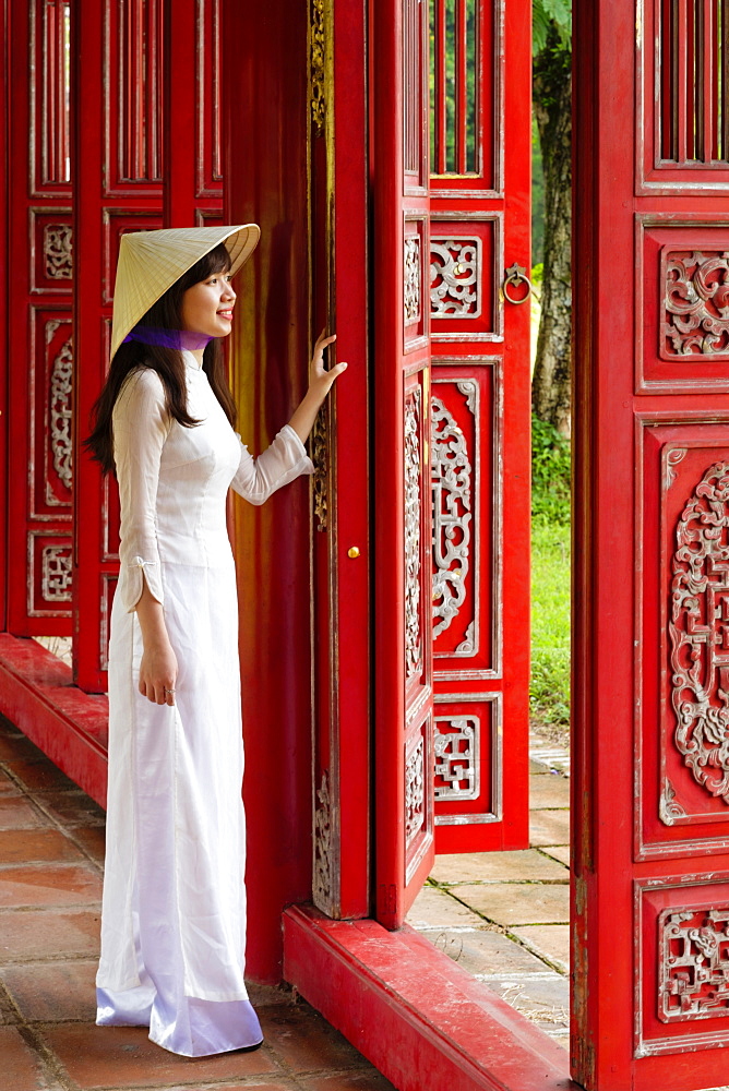 A woman in a traditional Ao Dai dress and Non La conical hat in the Forbidden Purple City of Hue, UNESCO World Heritage Site, Thua Thien Hue, Vietnam, Indochina, Southeast Asia, Asia