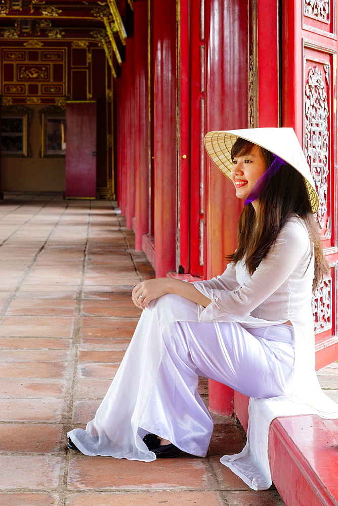 A woman in a traditional Ao Dai dress and Non La conical hat in the Forbidden Purple City of Hue, UNESCO World Heritage Site, Thua Thien Hue, Vietnam, Indochina, Southeast Asia, Asia