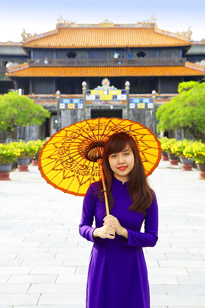 Woman in a traditional Ao Dai dress with a paper parasol in the Forbidden Purple City of Hue, UNESCO World Heritage Site, Thua Thien Hue, Vietnam, Indochina, Southeast Asia, Asia