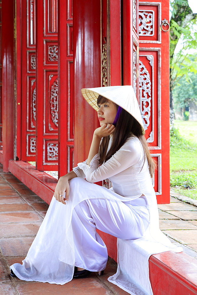 A woman in a traditional Ao Dai dress and Non La conical hat in the Forbidden Purple City of Hue, UNESCO World Heritage Site, Thua Thien Hue, Vietnam, Indochina, Southeast Asia, Asia