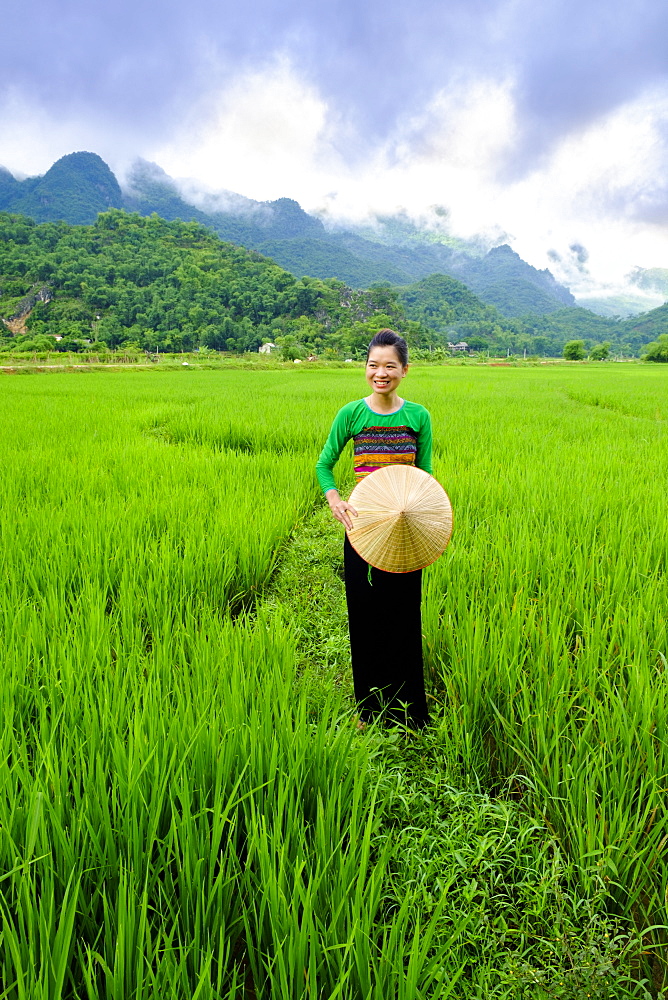 Local White Tai indigenous woman in traditional clothing standing in rice fields, Mai Chau, Hoa Binh, Vietnam, Indochina, Southeast Asia, Asia