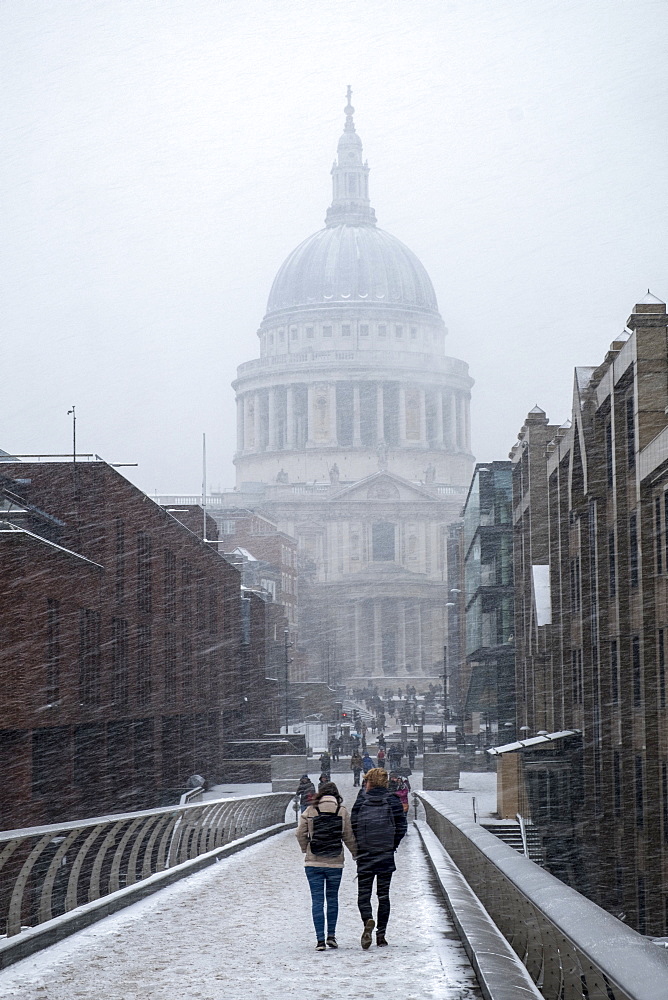 View of St. Paul's Cathedral and the Millennium Bridge in snow, London, England, United Kingdom, Europe