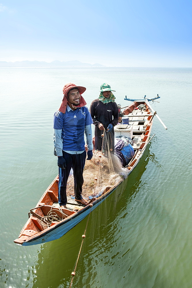 Fishermen in a wooden canoe near Kep, Cambodia, Indochina, Southeast Asia, Asia