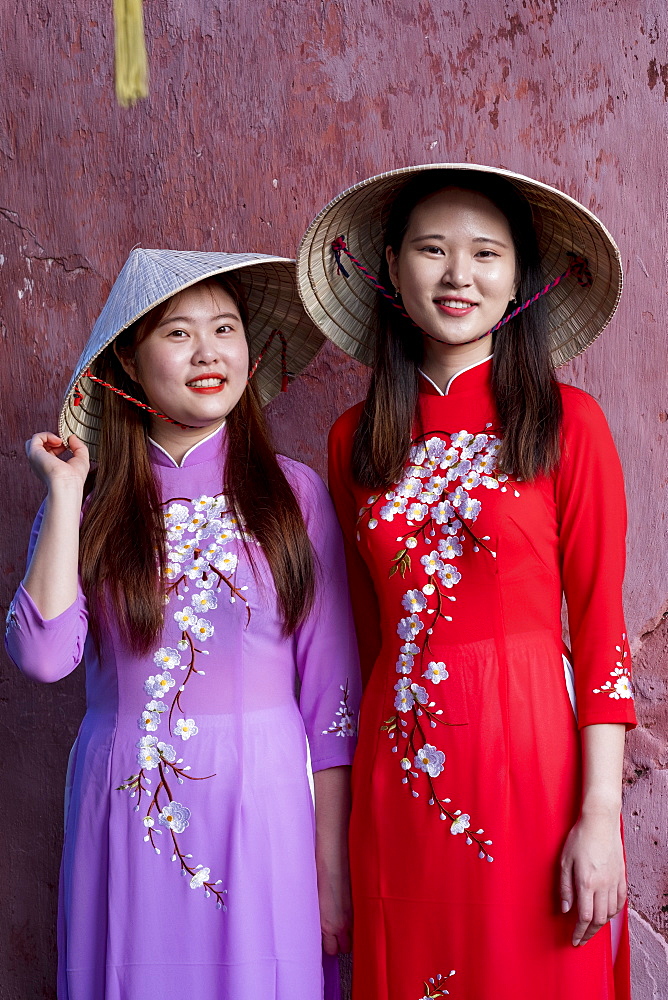 Young Vietnamese women wearing a traditional Ao Dai dress, Vietnam, Indochina, Southeast Asia, Asia