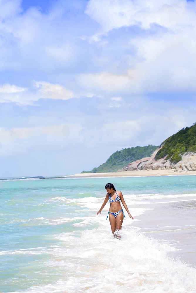 An attractive young Brazilian woman on Espelho Beach (Mirror Beach), Trancoso, Bahia, Brazil, South America