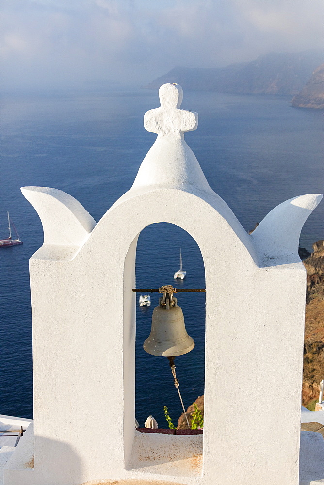 The white steeple of the church and the blue Aegean Sea as symbols of Greece, Oia, Santorini, Cyclades, Greek Islands, Greece, Europe