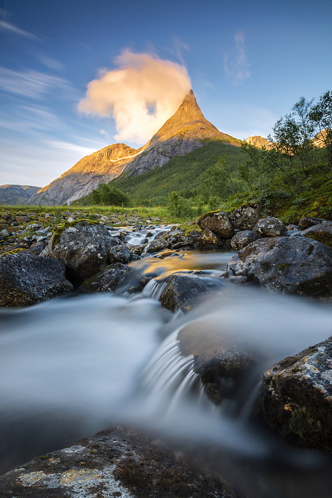 Waterfall frames the Stetinden mountain peak illuminated by midnight sun, Tysfjord, Nordland, Norway, Scandinavia, Europe