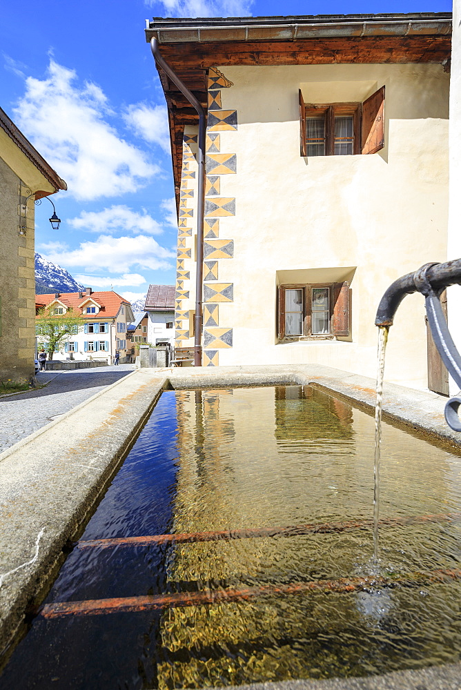 Fountain in the alleys of the alpine village, Guarda, Inn District, Lower Engadine, Canton of Graudbunden, Switzerland, Europe