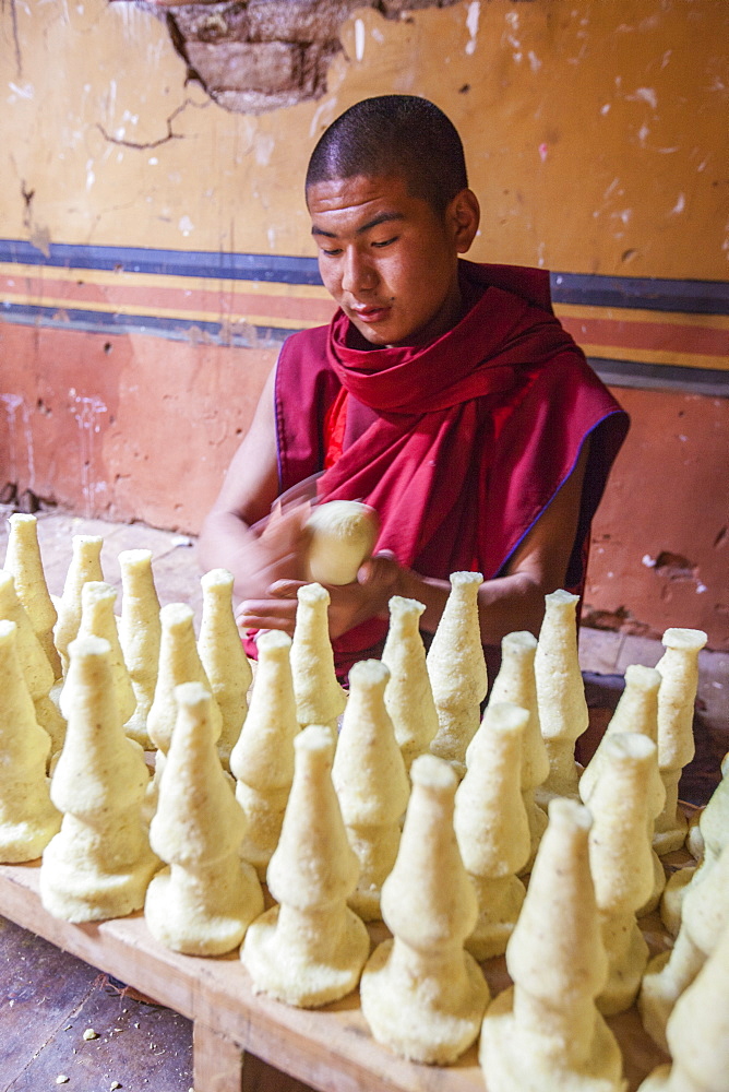 Young monk at work at the school of the Buddhist religion in Punakha, Bhutan, Asia