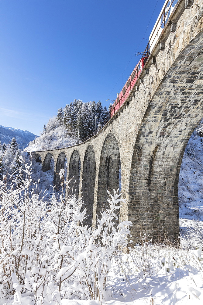 Bernina Express train on Landwasser Viadukt, UNESCO World Heritage Site, Filisur, Albula Valley, Canton of Graubunden, Switzerland, Europe