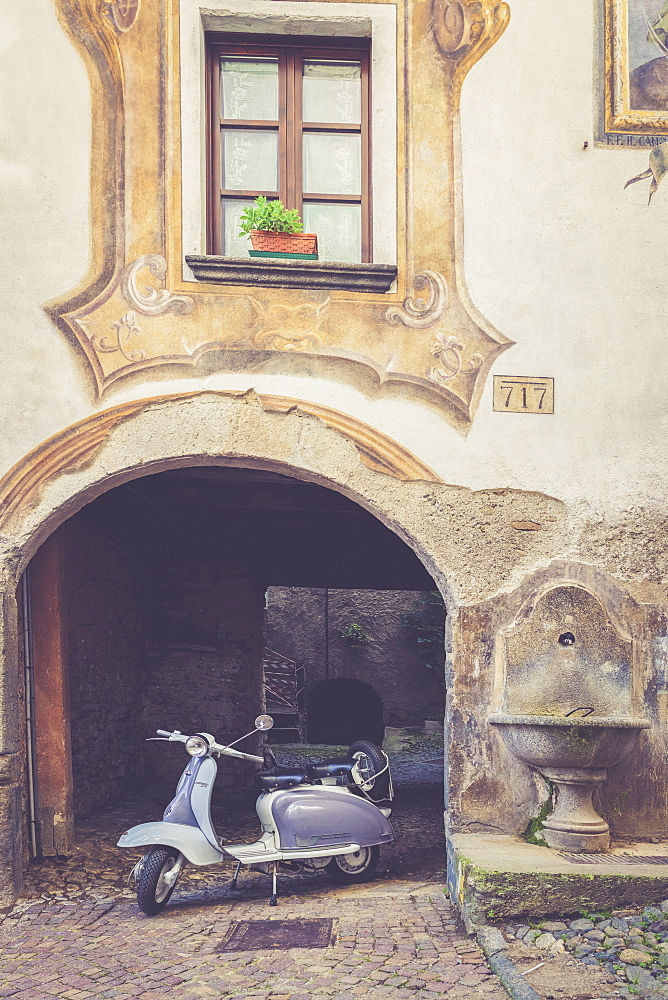 A white and grey Lambretta Innocenti scooter in the old town, Morbegno, Sondrio, Valtellina, Lombardy, Italy, Europe