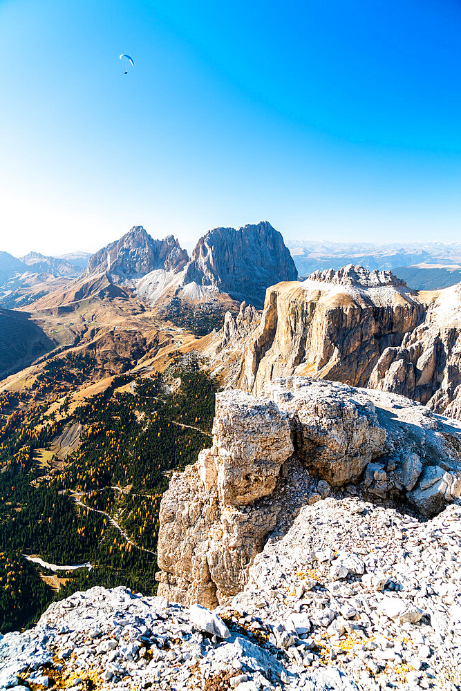 Paragliding over Sassolungo, Sassopiatto and Sella Pass in autumn seen from Sass Pordoi, Dolomites, Trentino, Italy, Europe