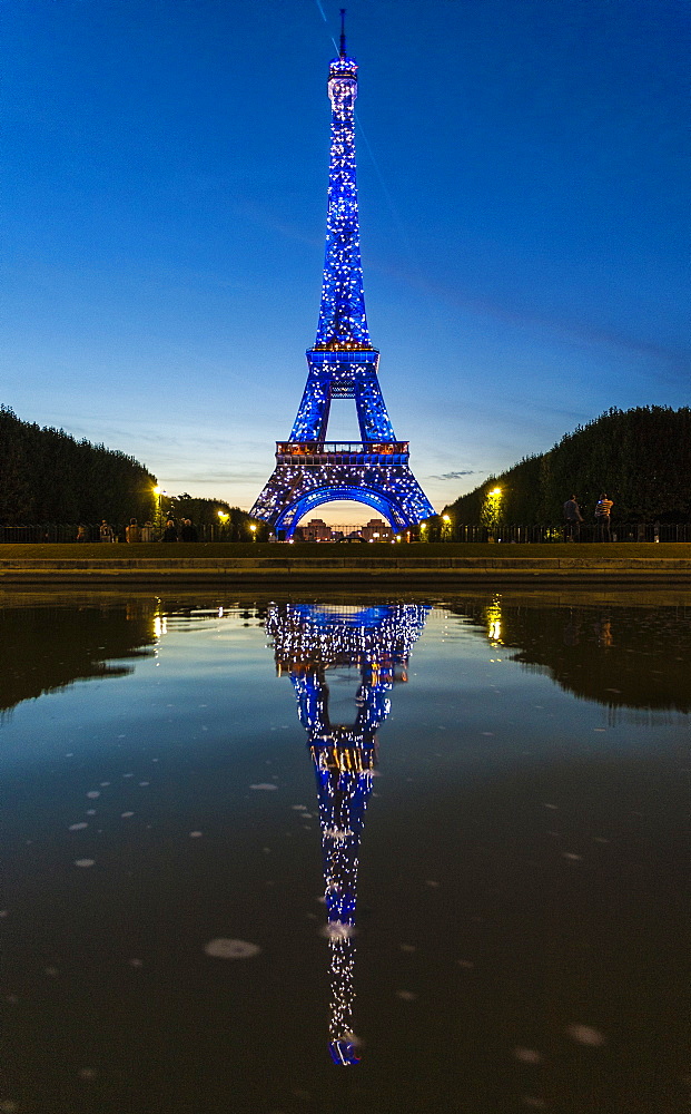 Colored lights illuminate the Eiffel Tower, Champ de Mars, Paris, France, Europe