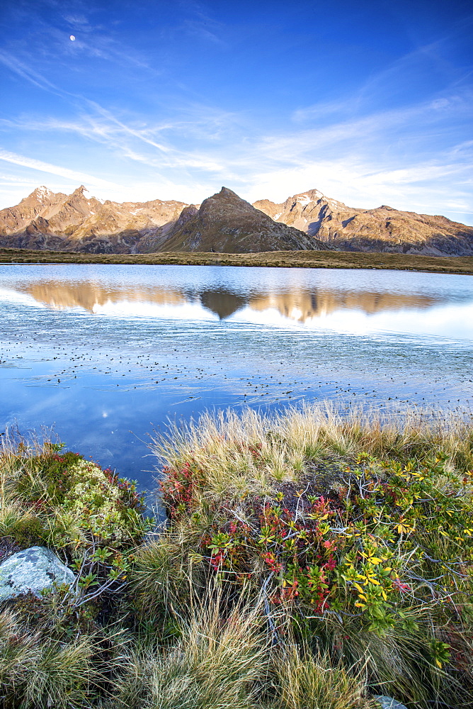 Peak Tambo and Peak Piani are reflected in Lake Andossi at sunrise, Spluga Valley, Valtellina, Lombardy, Italy, Europe