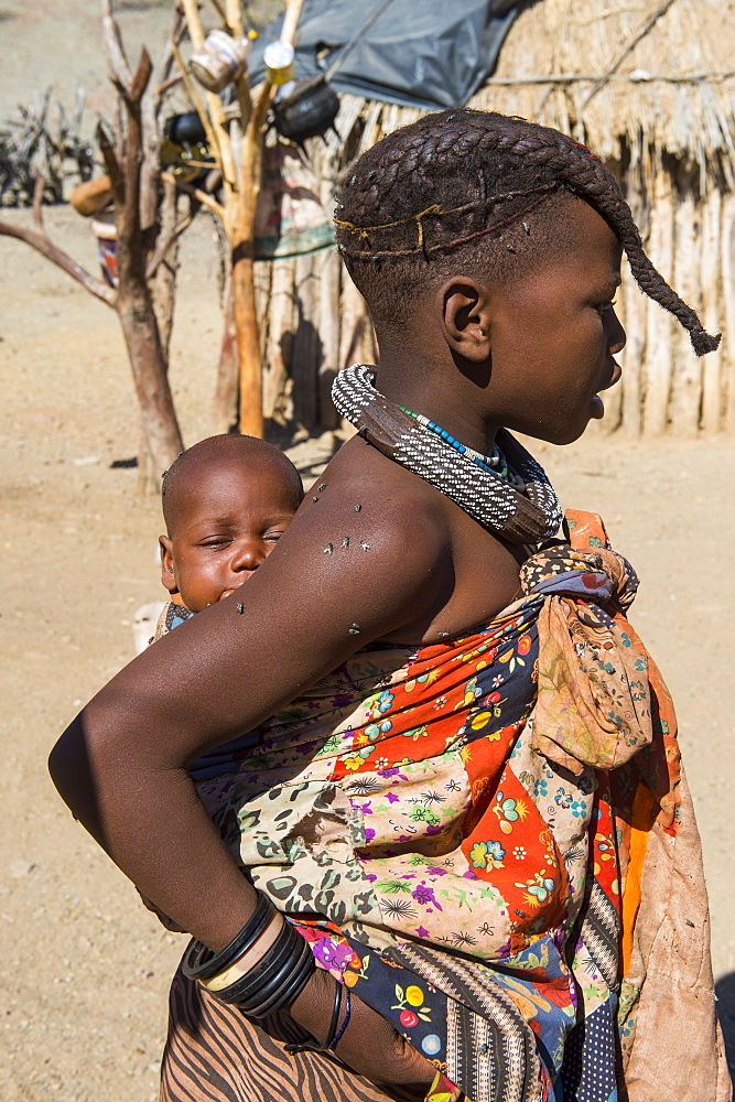 Himba girl carrying a baby, Kaokoland, Namibia, Africa