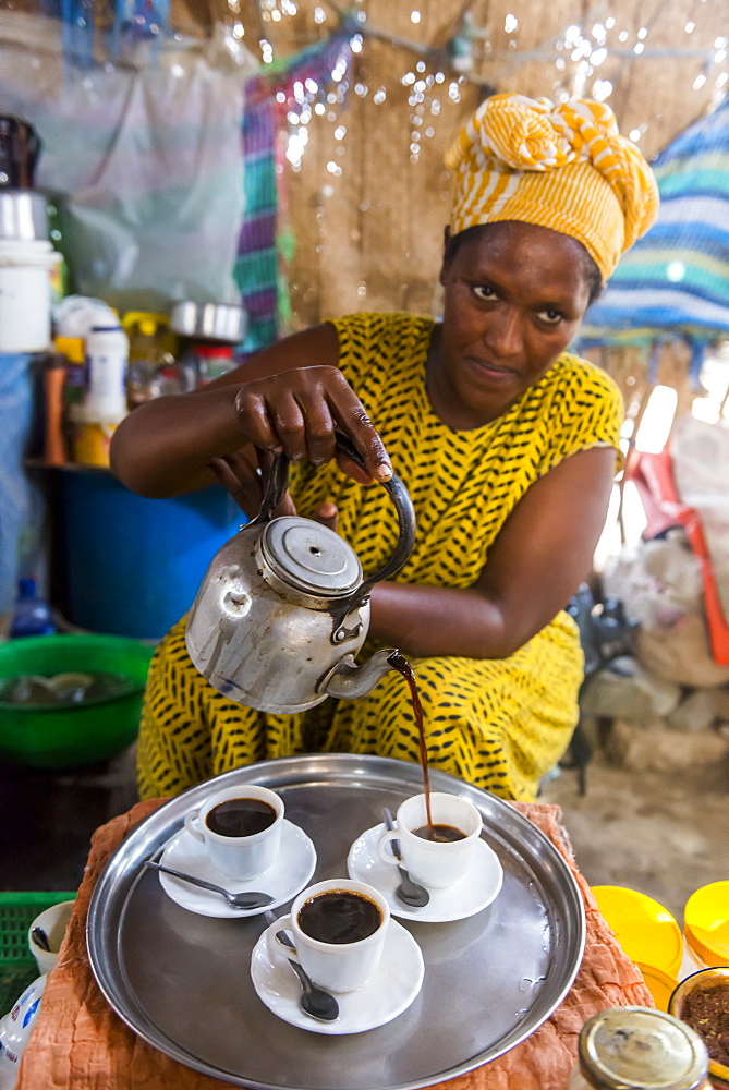 Woman serving Ethiopian coffee, Danakil depression, Ethiopia, Africa