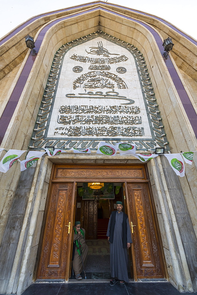 Sufi men standing in the Maruf al-Karkhi Sufi Mosque, Baghdad, Iraq, Middle East