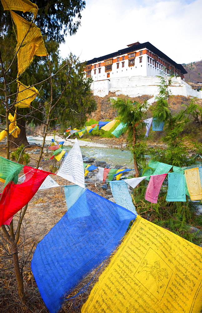 Prayer flags and Rinpung Dzong, Paro District, Bhutan, Asia