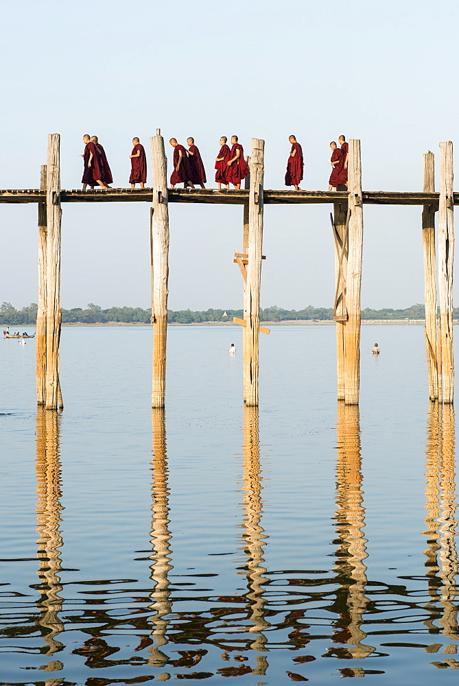 Monks crossing the U Bien bridge across Taungthaman Lake, Amarapura, Mandalay, Myanmar (Burma), Asia