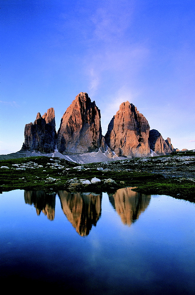 Dolomites, italy. South tyrol. Area of the three chimneys,from left to right: small chimney 2857 m; big chimney 2999 m; western chimney 2973 m; reflecting in a small puddle of water