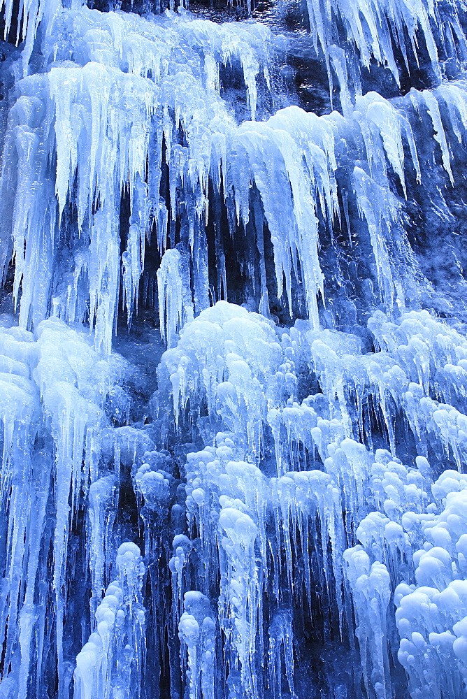 Icicles hanging from steep rock wall, partnachklamm, garmisch, germany