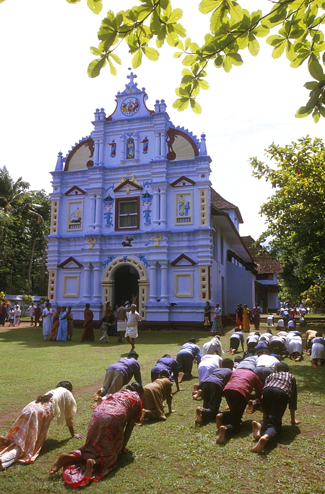 India - religion - christian pilgrims walking around church on hands and knees as penance, good friday, valliappally, kerala