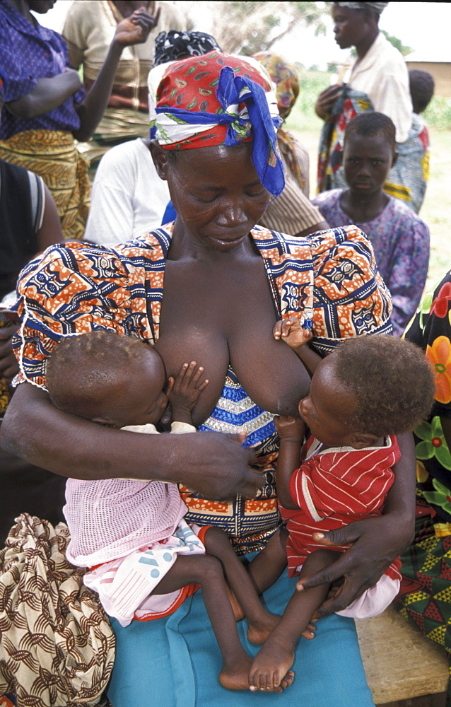 Ghana woman feeding twins bongo, bolgatanga