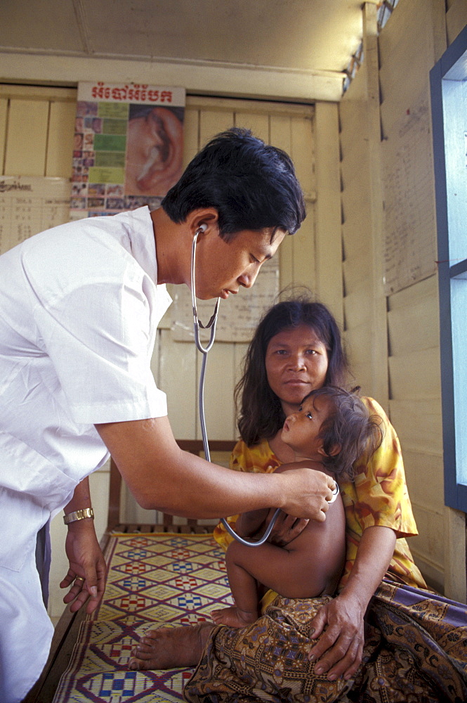 Cambodia doctor examining child at floating clinic on tonle sap