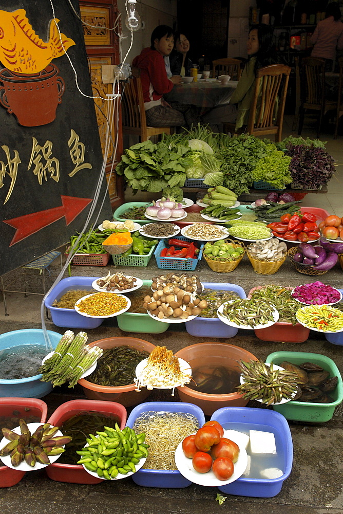 China display of fresh vegetables outsdie a restaurant dali town, yunnan province.