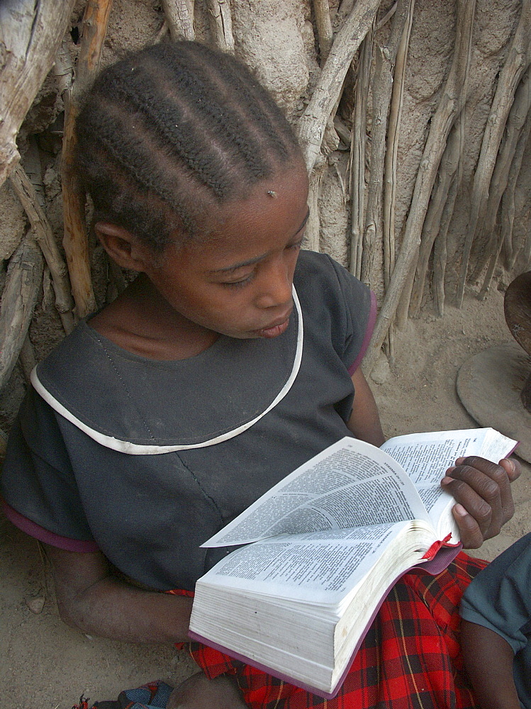 Watatulu girl reading bible, tanzania. Mwankale