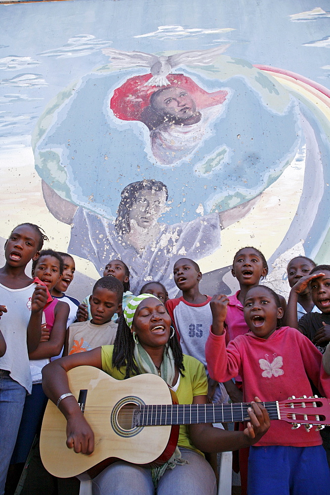 Namibia children, many of whom aids orphans positive themselves at bernard nordkamp (youth) center, katatura, a black township of windhoek, (dating from apartheid). Singing christian songs with a theme of protecting children against abuse, pregnancy, aids raising their spirits