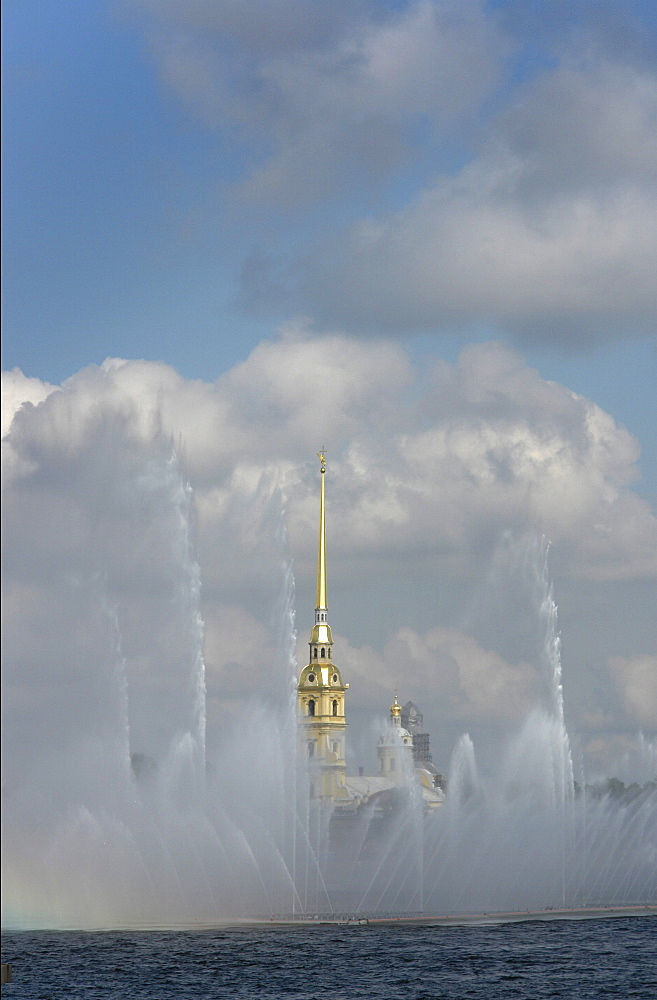 Russia view across river neva towards peter paul fortressm through fountain display which floats on river. Saint petersbur