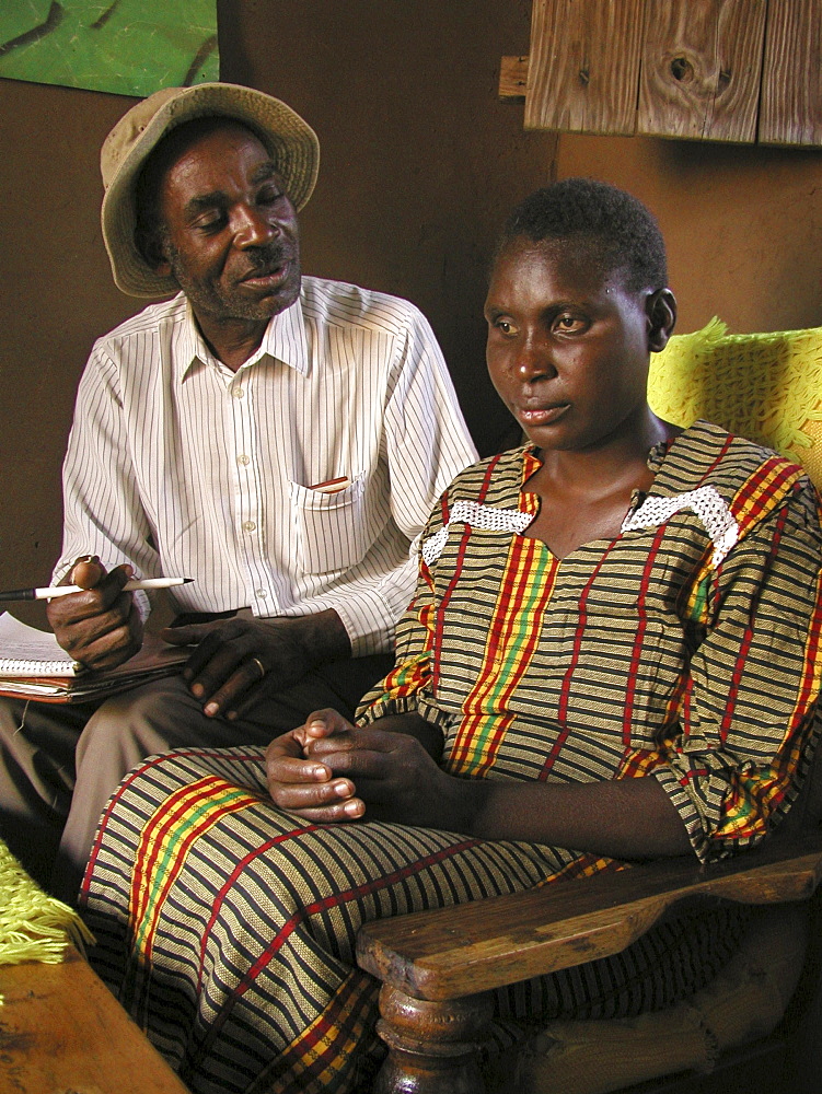 Social worker (left) visiting blind woman with aids, tanzania. Musoma