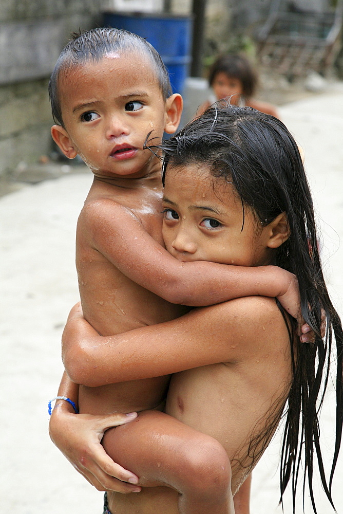 Philippines children playing in the street of the slum of bagnong silangan, quezon city, manila