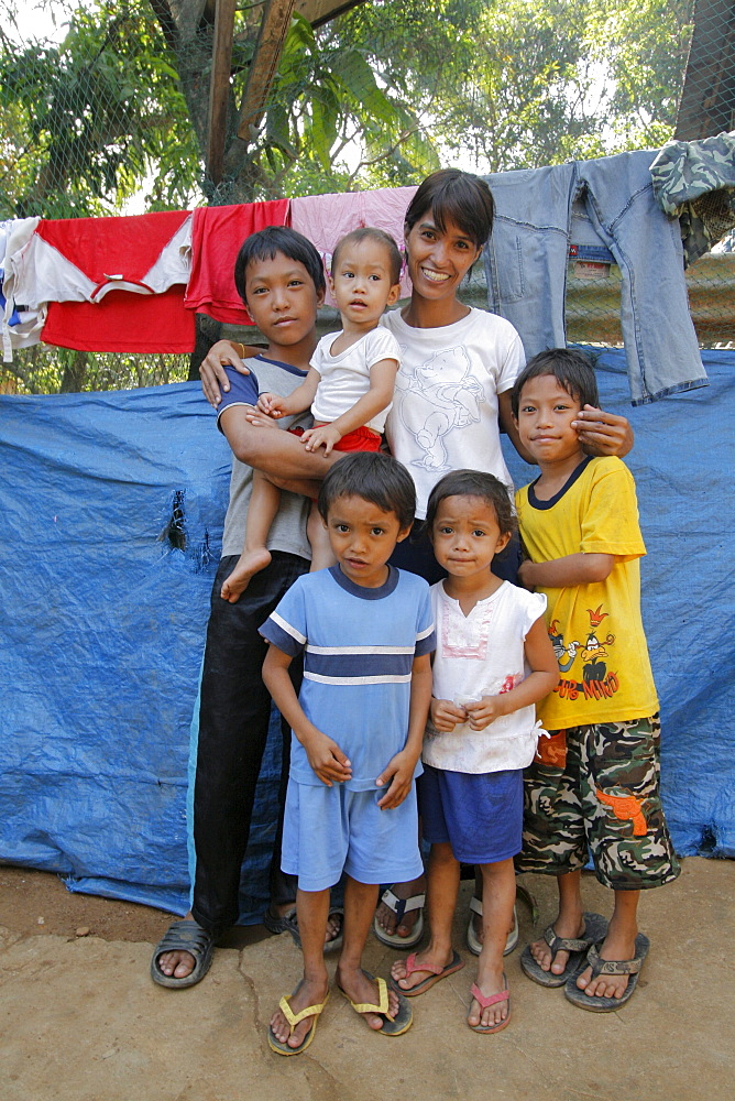 Philippines a mother and her children at home in their slum dwelling, bagong silangan, quezon city, manila