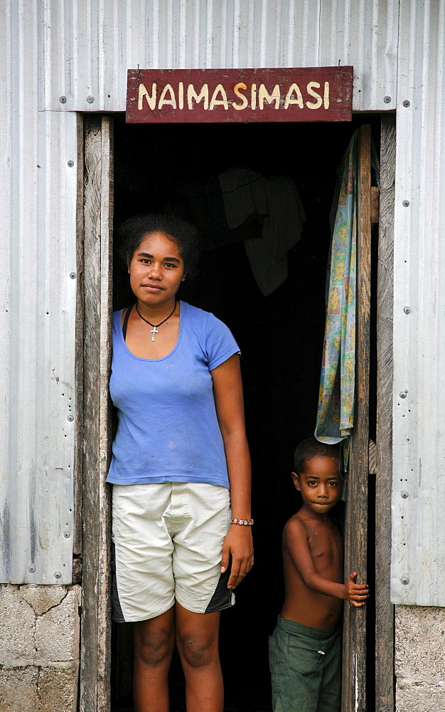 Fiji woman and child in doorway, lavena village, taveuni photo by sean sprague