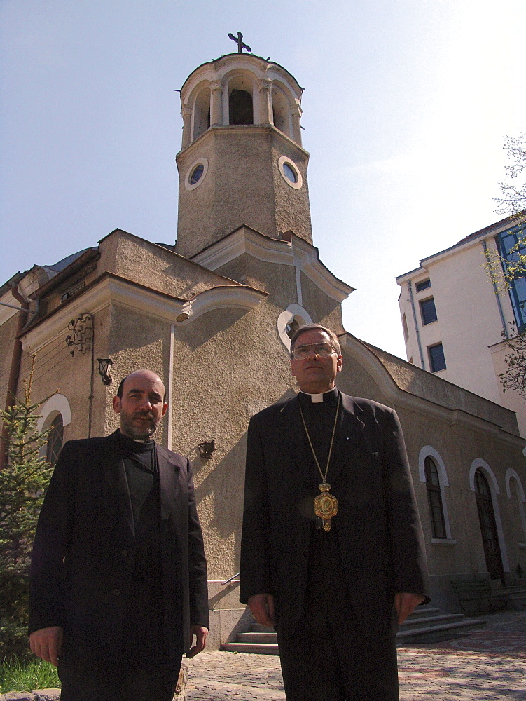 Religion, bulgaria. Bishop christo proykov (right) standing with father blagovast, standing in front of the assumption church, sofia. They are byzantine catholics