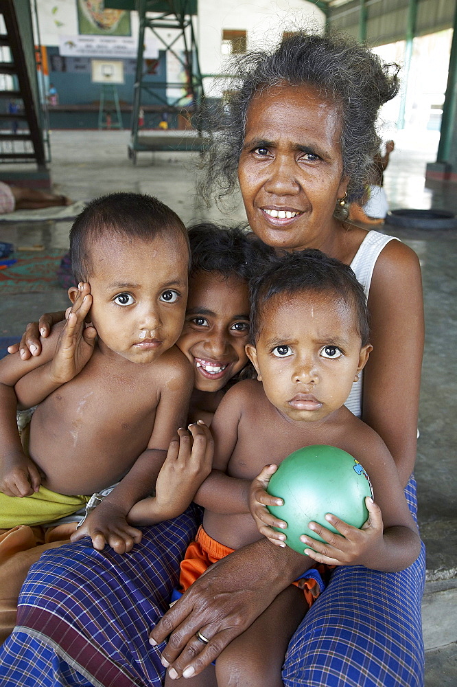 East timor. Camp for internally displaced people (idps) at the don bosco center in dili. Woman with her children