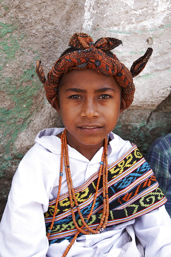 East timor boy wearing traditional dress including ikat weaves and beads, oecussi-ambeno