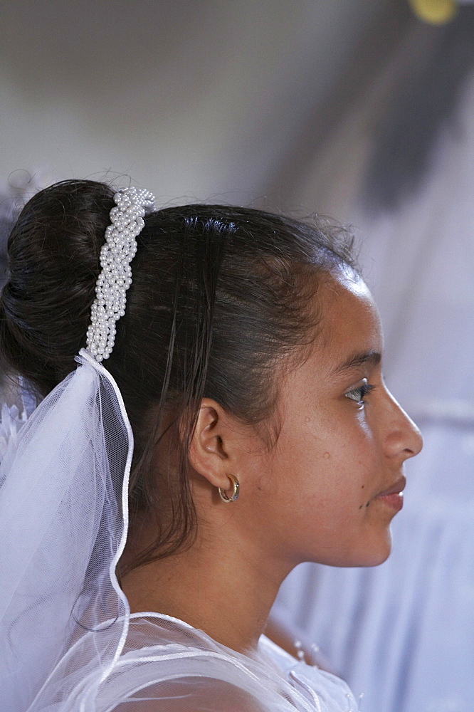 Guatemala catholic first communion and mass at remate, el peten. girl waiting to give first confession