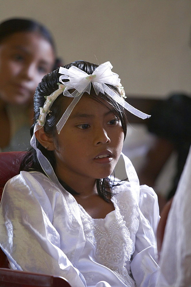 Guatemala catholic first communion and mass at remate, el peten. girl waiting to give first confession