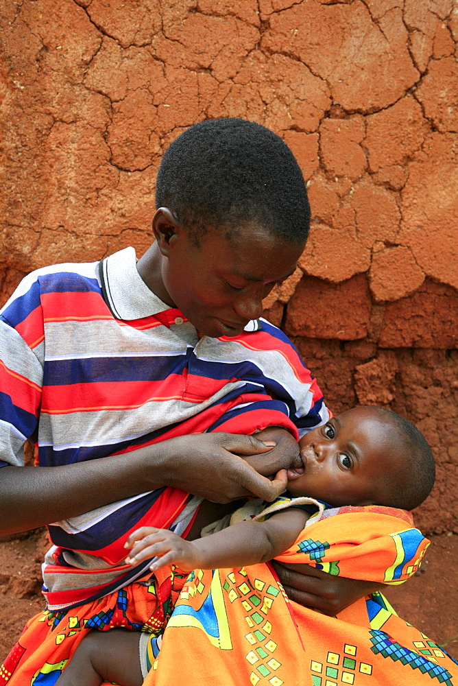 Burundi woman breast feeding baby. Gitera.