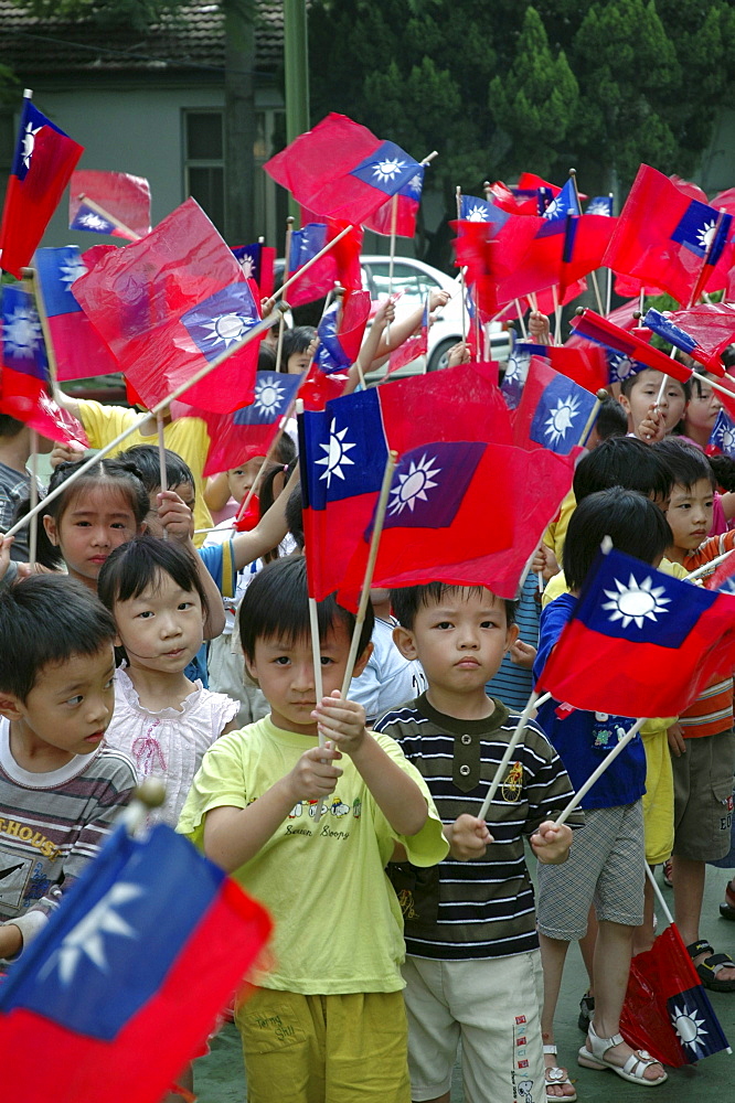 Street scene, taiwan. Kindergarten children waving the flag of taiwan, taichung