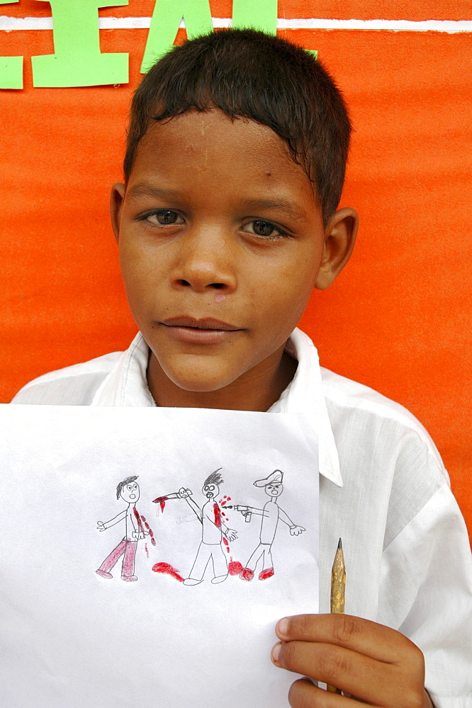 Colombia schoolboy showing his art depicting violence which he had witnessed at barrancabermeja, one of the most dangerous cities in the country