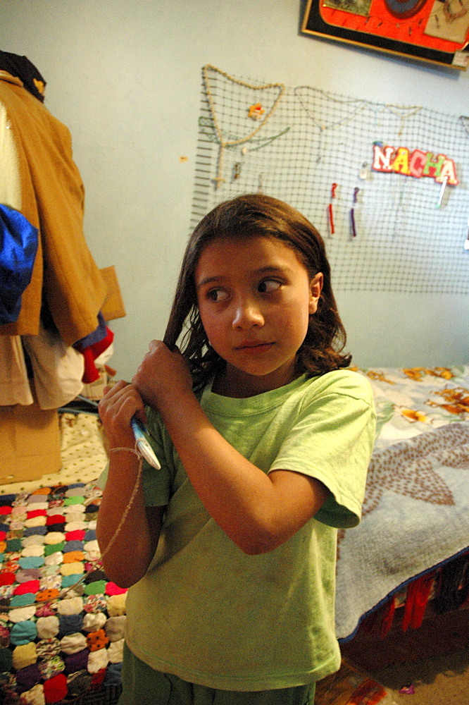 Colombia marly juliet, 7, of the slum of altos de cazuca, bogota, brushing her hair