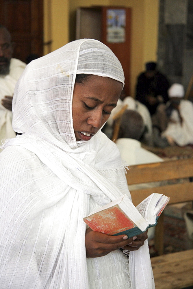 Ethiopia the maryam feast, feast of mary, at axum. Woman reading scriptures, inside the church of saint mary of zion