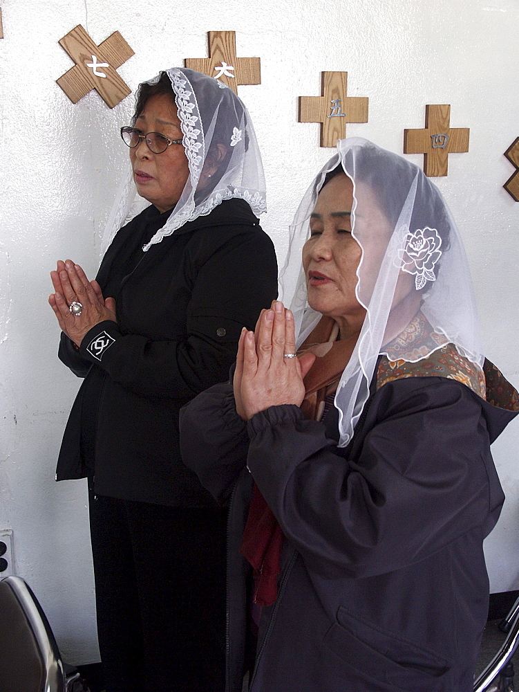 Korea women praying at catholic chapel in karakan wholesale food market, seoul