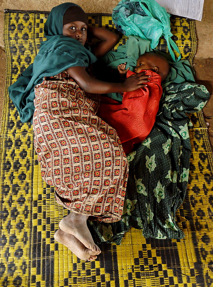 Kenya,dadaab refugees camp, somalian border gtz hospital ,the camps were set up around the town of dadaab beginning in 1991 when civil wars erupted on a grand scale in somalia (16 rival factions were involved). The wars, along with a prolonged drought, forced more than 900,000 somalis to flee to neighboring countries. Approximately 400,000 of them, many of whom were in a serious state of exhaustion and starvation, took refuge in kenya. Since then, a majority have returned to their country. However, some 131,000 somalis remain in kenya, and 110,000 are in dadaab, along with some sudanese, ugandans, and about 3,000 ethiopians women waiting the receive care from gtz ngo at the local hospital 